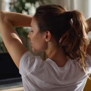 woman stretching at home office as part of a holistic approach to pain relief