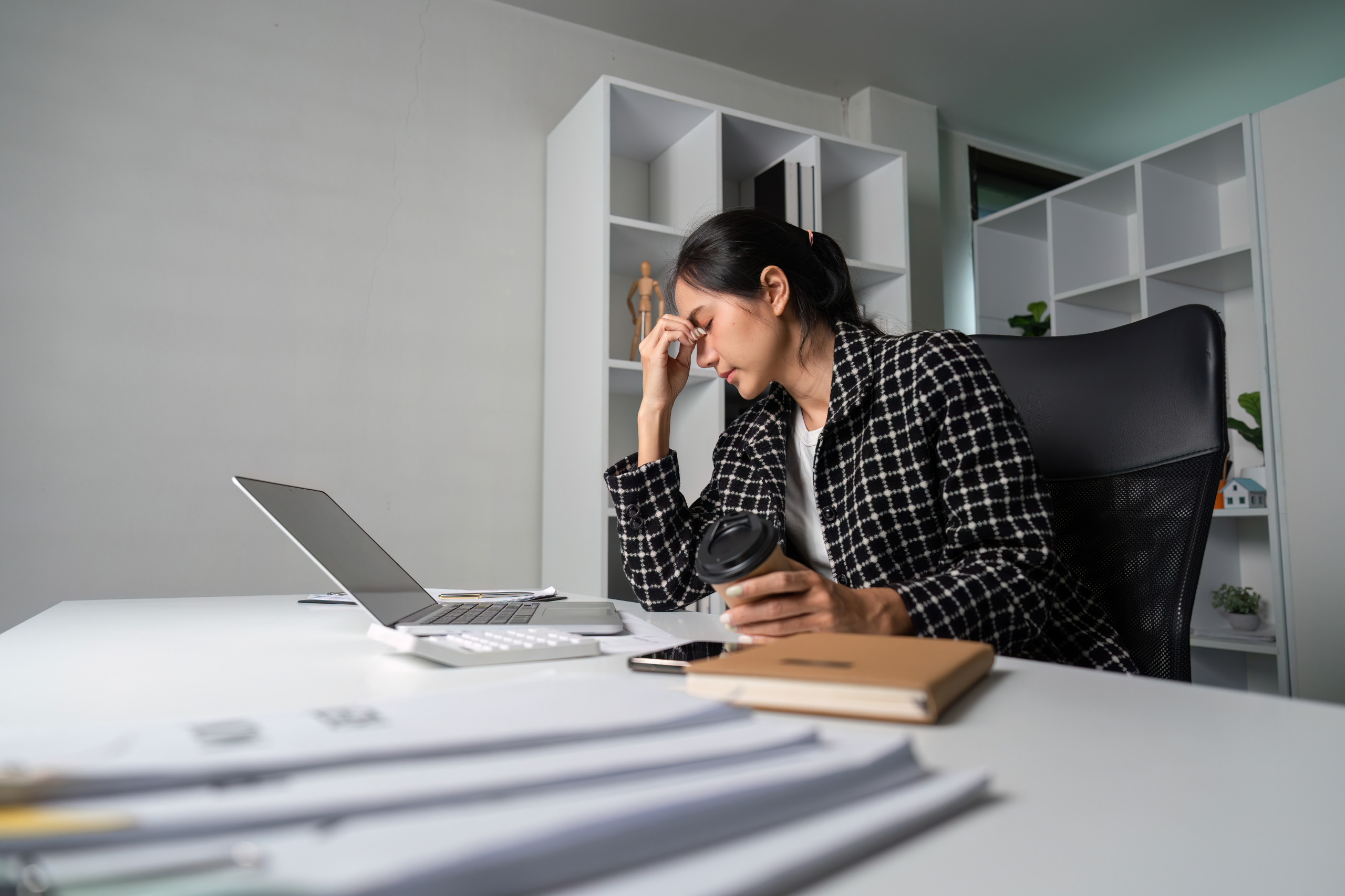 stressed young businesswoman overwhelmed by modern stress