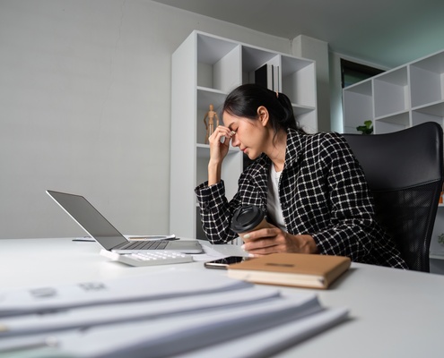 stressed young businesswoman overwhelmed by modern stress