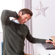 young man lower back ache relief due to poor desk posture