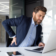 businessman his office with shoulder pain where back stretcher is helpful