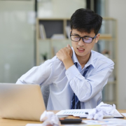 exhausted businessman suffering shoulders pain from work