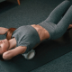 young woman in yoga clothes doing foam roller fitness indoors