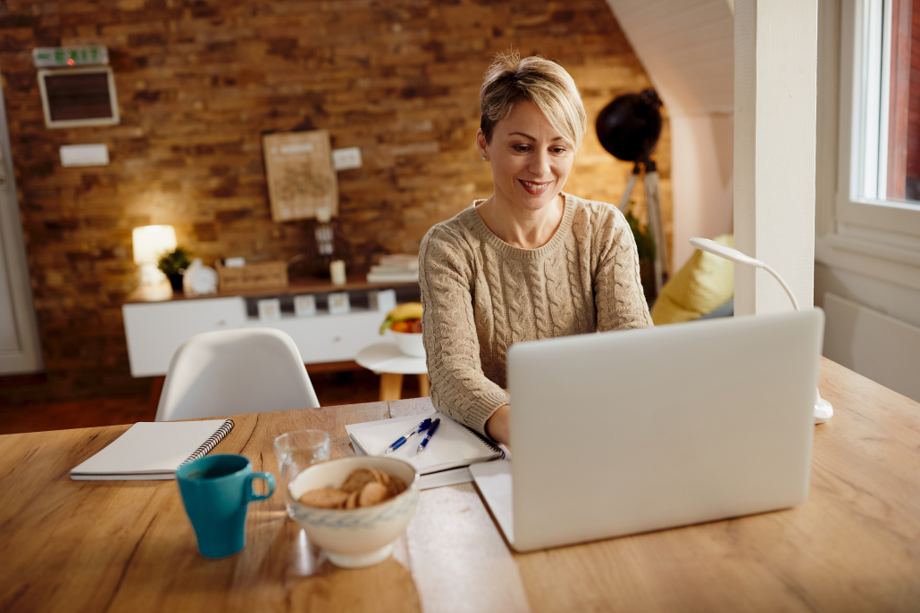 happy woman using laptop while working home