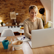 happy woman using laptop while working home