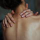 Person experiencing extreme pain relief using an acupressure mat at home