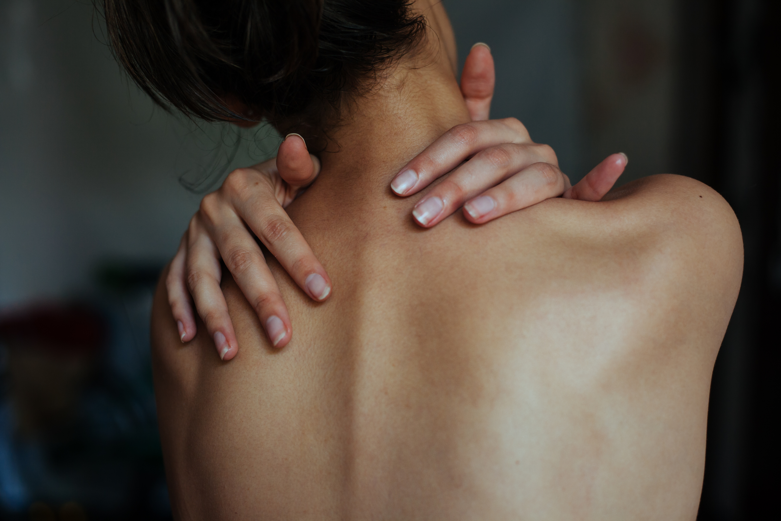 extreme pain relief acupressure Person experiencing extreme pain relief using an acupressure mat at home