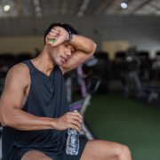 soreness after workout - athlete stretching sore muscles during post workout recovery