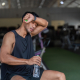 soreness after workout - athlete stretching sore muscles during post workout recovery