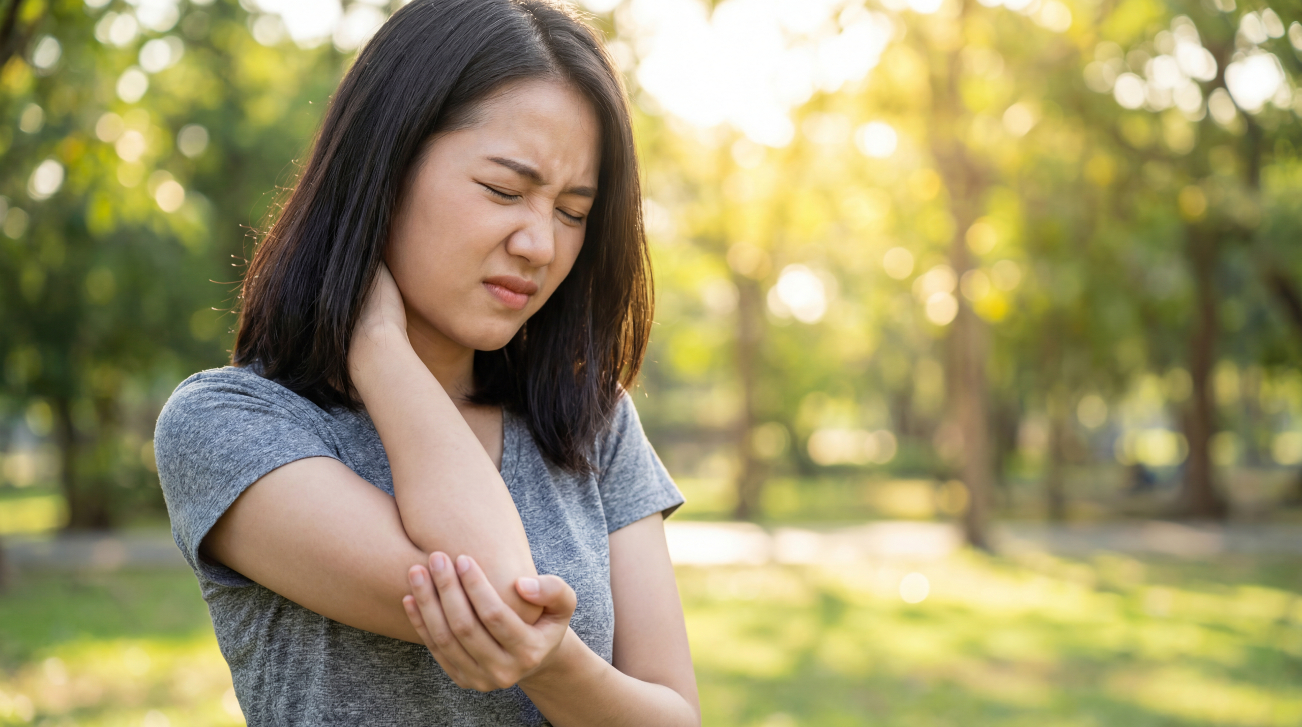 vecteezy young asian woman experiencing neck and arm pain outdoors 76981340 vecteezy young asian woman experiencing neck and arm pain outdoors 76981340