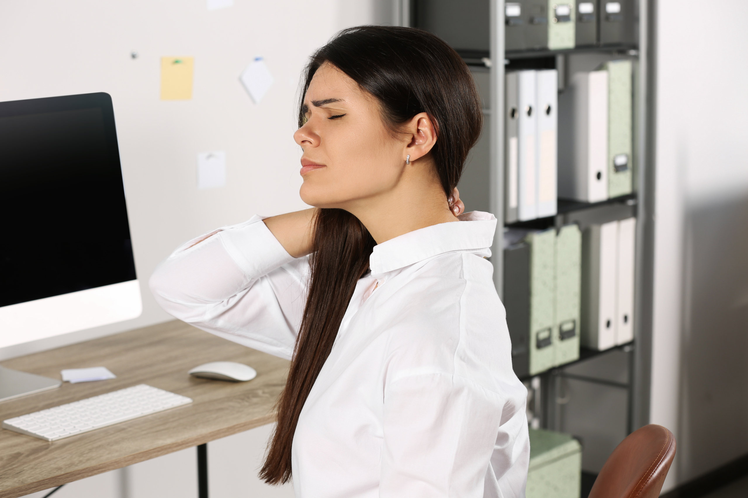 young woman experiencing neck tension relief after office work