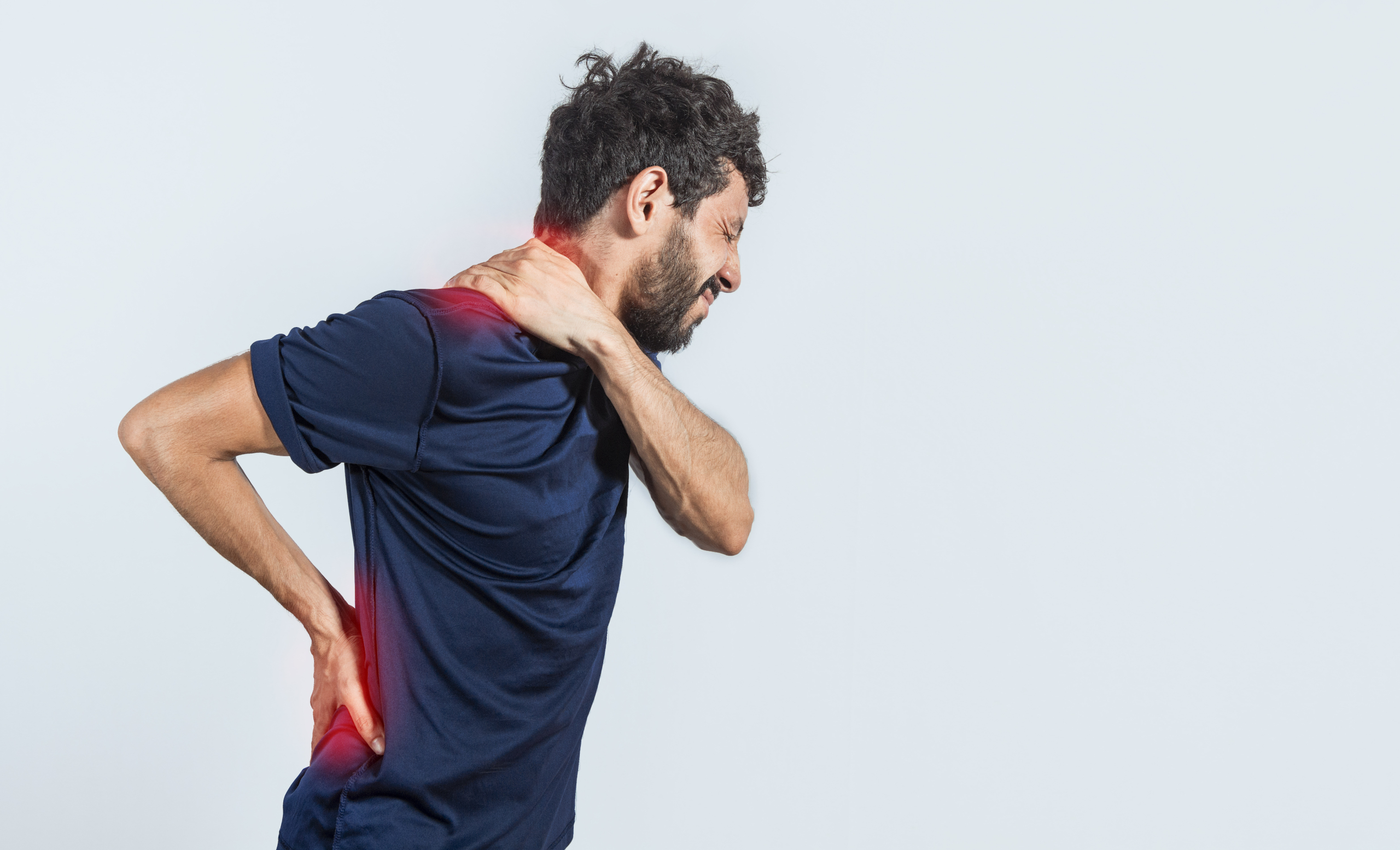 Adult waking with morning back pain who could benefit from using a lumbar pillow for sleeping each night