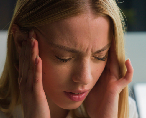 a woman having headache and opting for headache relief
