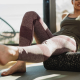 Person using a foam roller for tight hips on an exercise mat at home
