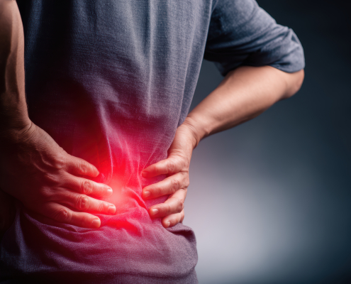 Person stretching to relieve lower back achiness after a long day at their desk