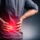 Person stretching to relieve lower back achiness after a long day at their desk
