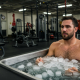 man taking ice after exercising at gym cold 71530792