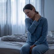 Woman pressing her neck and shoulders due to trigger point muscle tension