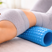woman using foam roller for back pain relief at home
