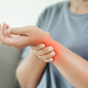 vecteezy closeup of woman sitting on sofa holds her swelling wrist hand 4572743