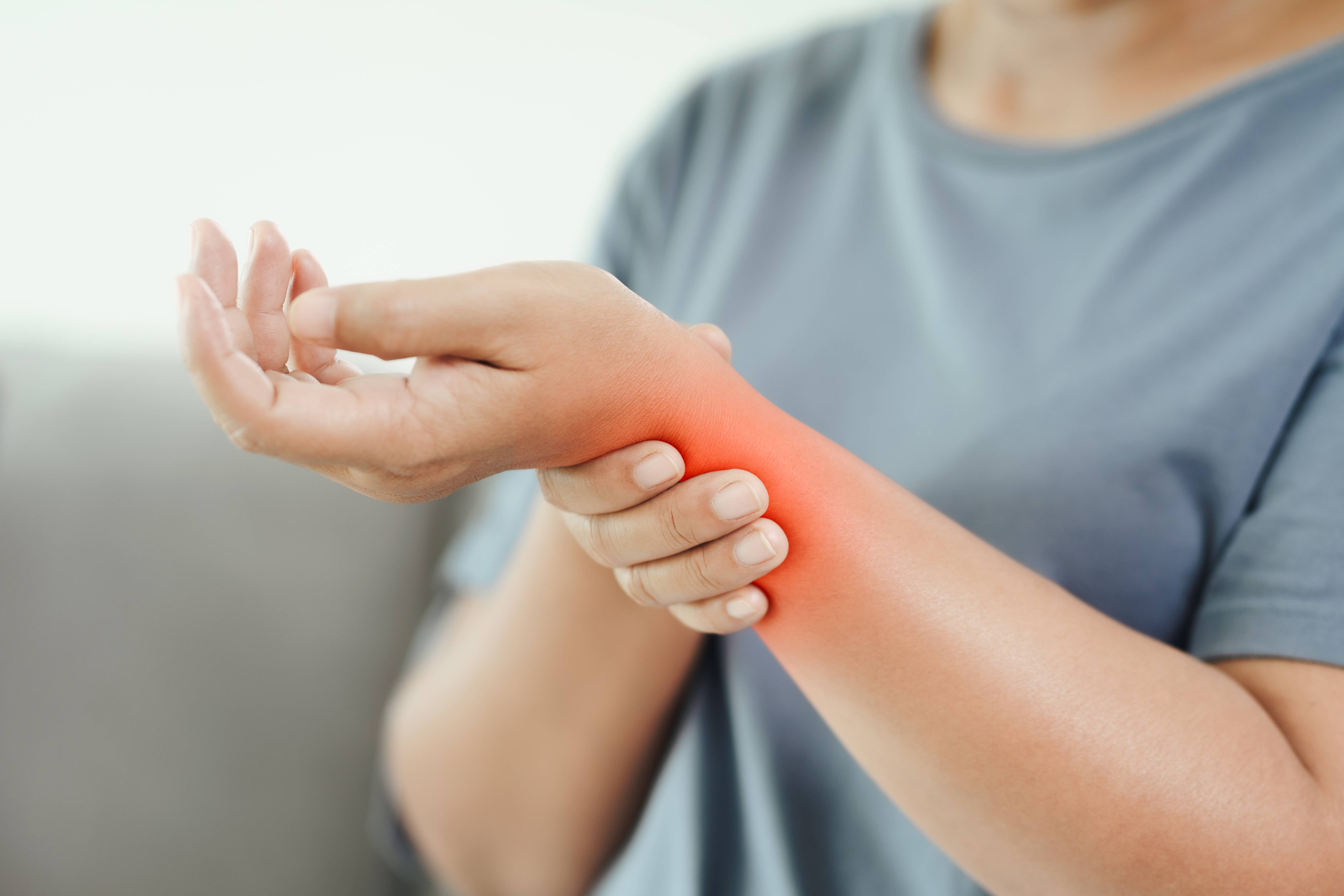 vecteezy closeup of woman sitting on sofa holds her swelling wrist hand 4572743