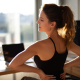 Woman performing one of several back flexibility exercises in her living room