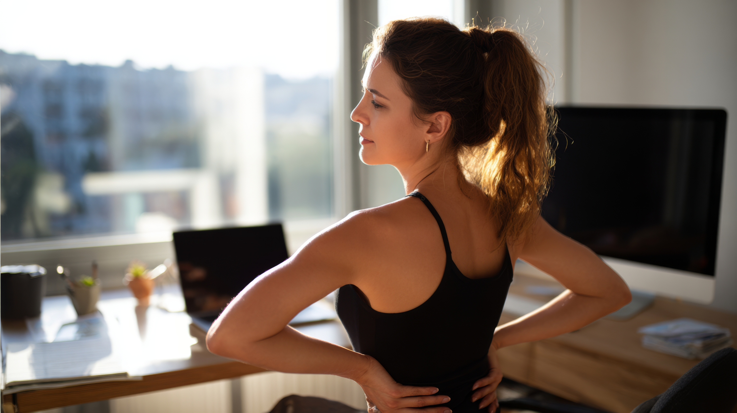 woman stretching spine back flexibility exercises Woman performing one of several back flexibility exercises in her living room