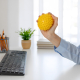Person using the benefits of vibrating massage ball therapy on a tense shoulder