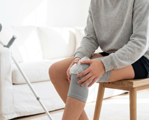 Person deciding when to use heat vs ice for pain after a minor injury