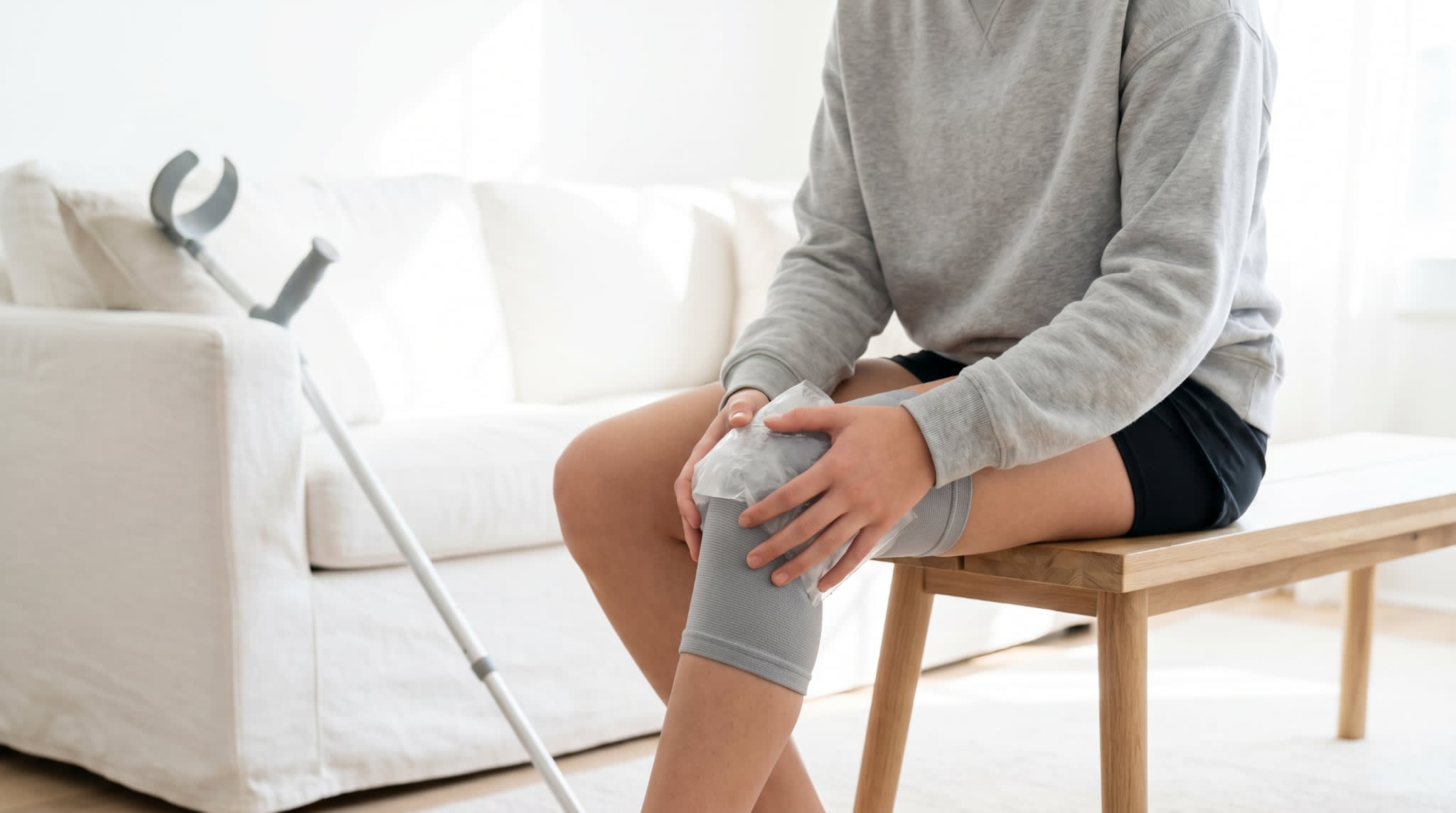 Person deciding when to use heat vs ice for pain after a minor injury