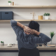 Slouched desk worker wondering does a posture corrector belt work for back ache