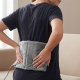 Person applying a hot cold pack for lower back pain