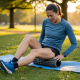Person using a foam roller for legs to ease quad and calf tightness