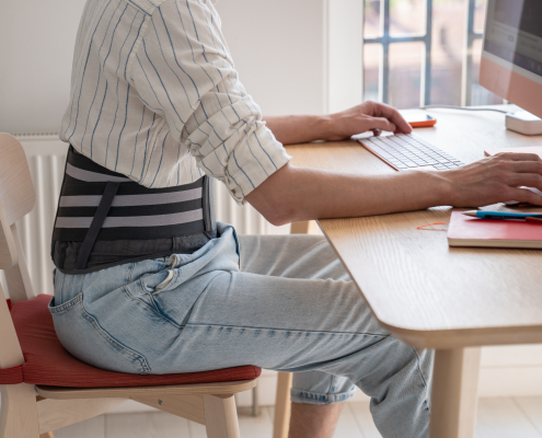 vecteezy man works on computer wears posture support belt on lower back 73252509