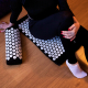 Woman relaxing on an acupressure mat, showing the lyfe focus acupressure mat benefits in practice