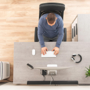 man using cold pack for back pain relief at home office desk
